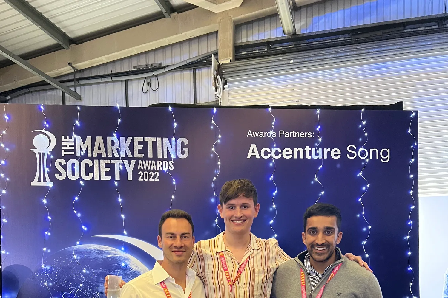 Alexej Pikovsky with two colleagues in front of The Marketing Society Awards 2022 backdrop